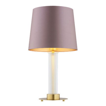 Glass table lamp with pink shade with the light bulb on.