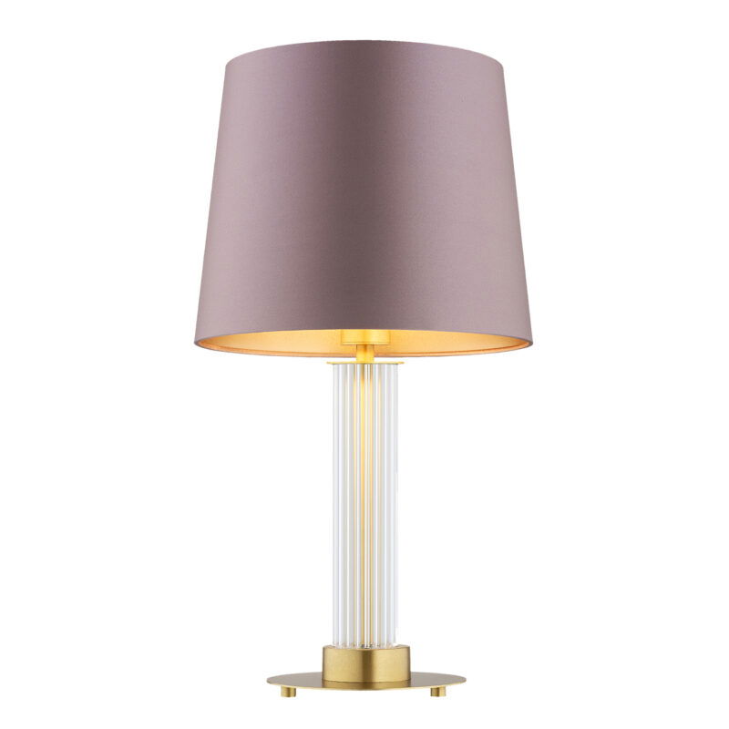 Glass table lamp with pink shade with the light bulb on.