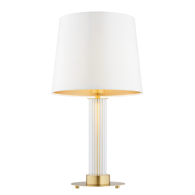 Glass table lamp with cream fabric shade and light bulb on.