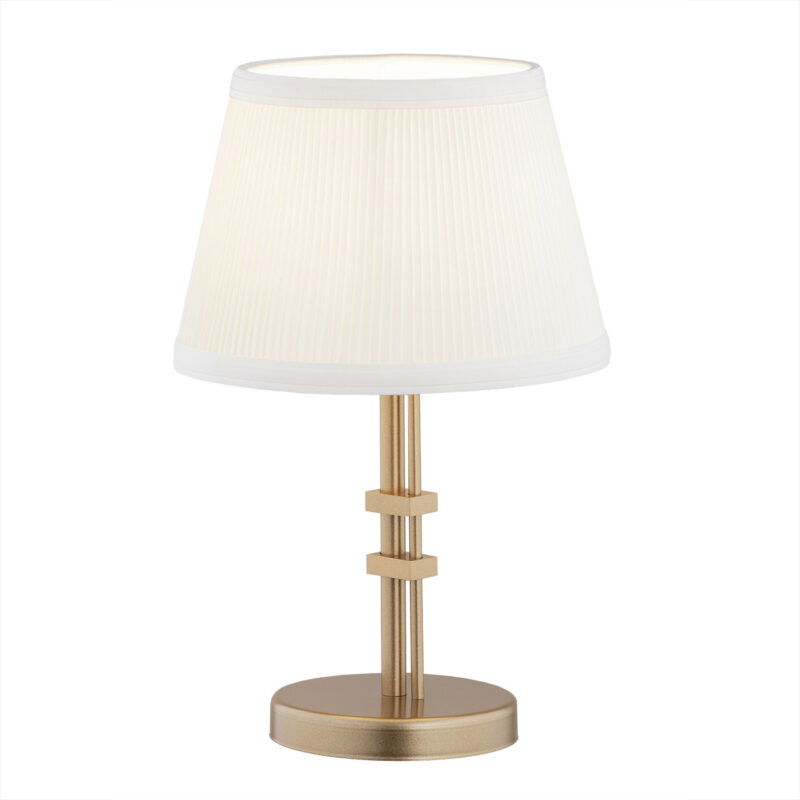 Old gold Arani table lamp with cream fabric shade and circular base with decorative clamps.