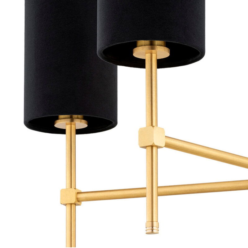 Close-up view of brushed brass arm structure on Aruzzo chandelier with black shades.