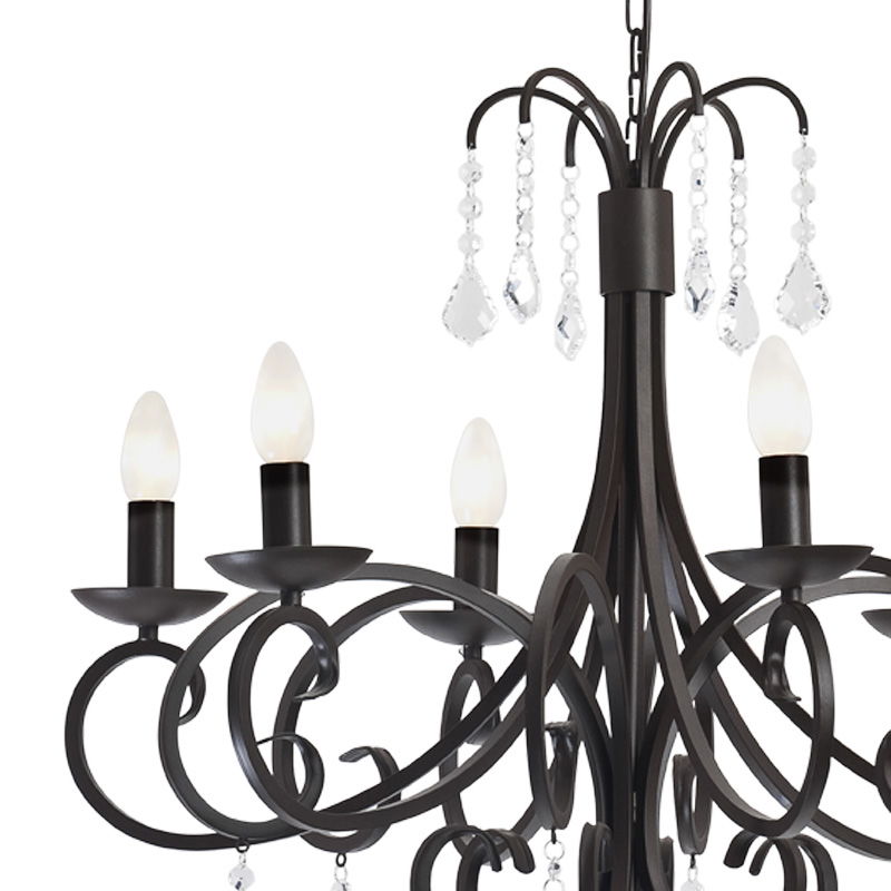 Close-up of Dema chandelier showing curved arms, candle holders and crystal droplets.