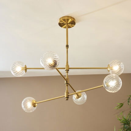 Upward angle of Deo Medium Pendant Lamp showing six glass shades radiating from central brass mount.
