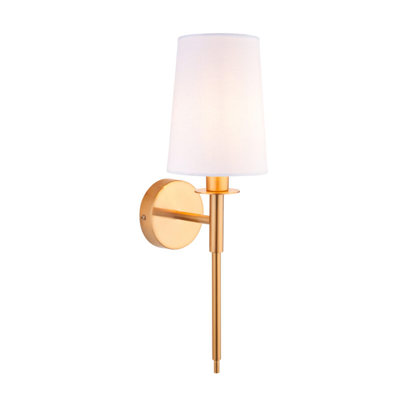 Left side view of lit Avel wall lamp with white fabric shade and brass finish against white. background.