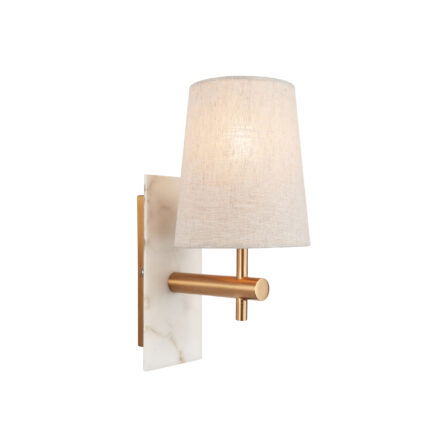 Side view of lit wall light with brass arm extending from white marble mount and glowing linen shade against white background.