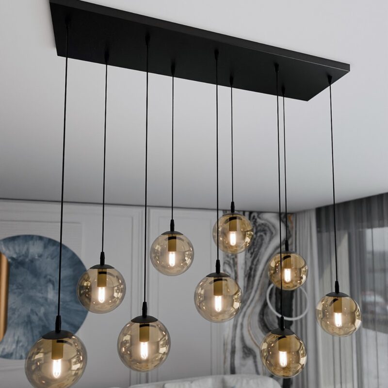 Kosmos pendant light close-up showing black ceiling canopy and amber globe arrangement.