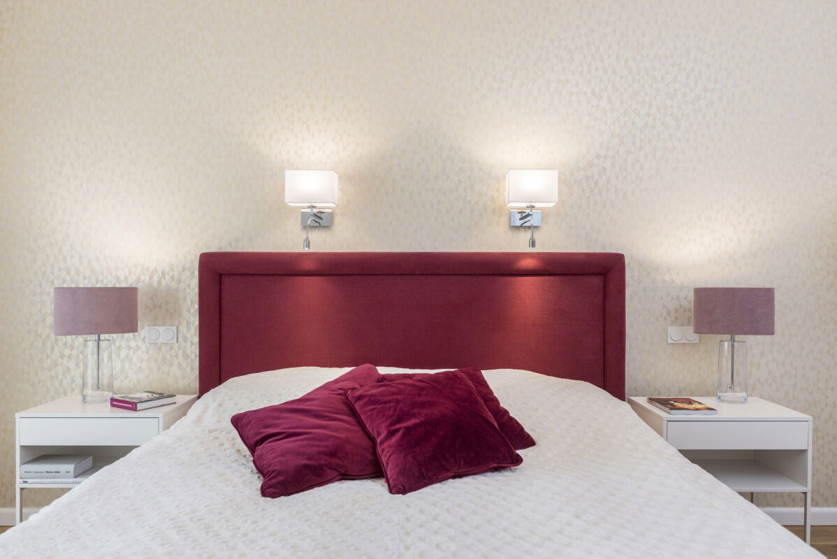 Laryi bedside wall light side view showing chrome mounting plate and LED reading light extension.
