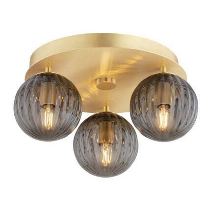 Brass Loma flush ceiling light with three lit smoked glass ribbed shades.