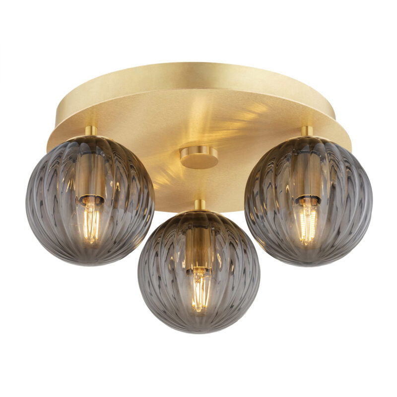 Brass Loma flush ceiling light with three lit smoked glass ribbed shades.