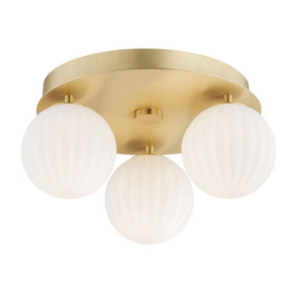 Brass Loma flush ceiling light with three lit opal white glass ribbed shades.