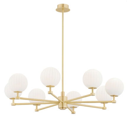 Loma brass chandelier with eight illuminated matt opal glass shades emitting warm white light.