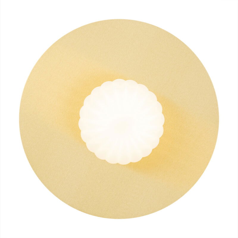 Front view of illuminated circular wall light with brass frame and opal glass shade.