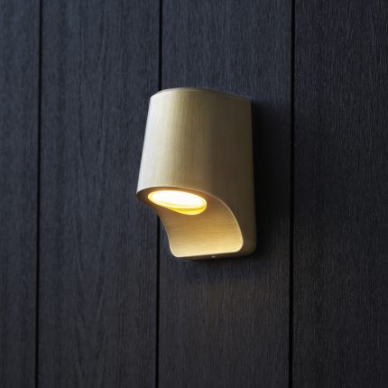 Close-up view from the right side of the Helix LED Outdoor Wall Light in Antique Brass, attached to an exterior wooden panel.