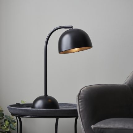 Close up view of the Odio Table Lamp with a matt black domed shade.