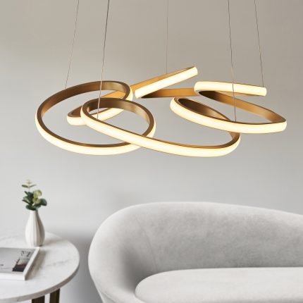 The Blaze LED Pendant Lamp in full view, displaying its distinctive swirl shape and gold detailing, with the LED light turned off.