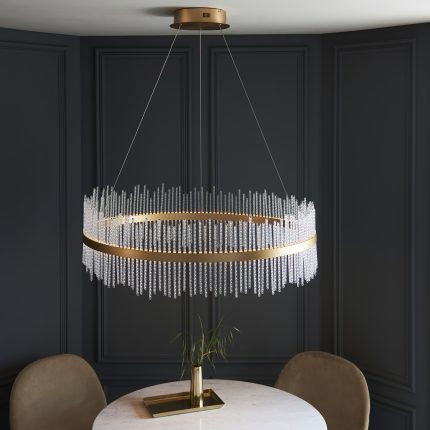 Downward view of the Netus Extra Large Pendant Light, 89cm gold ring, hanging above a round dining table.