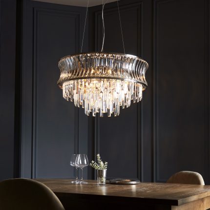 Bottom half of the Ares Chandelier with crystal glass, polished nickel finish, and nine lights, hanging above a table.
