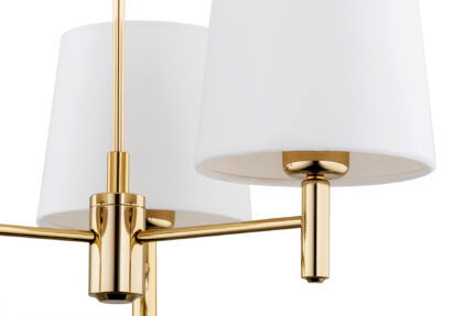 View of one of three brass arms with a cream lampshade.