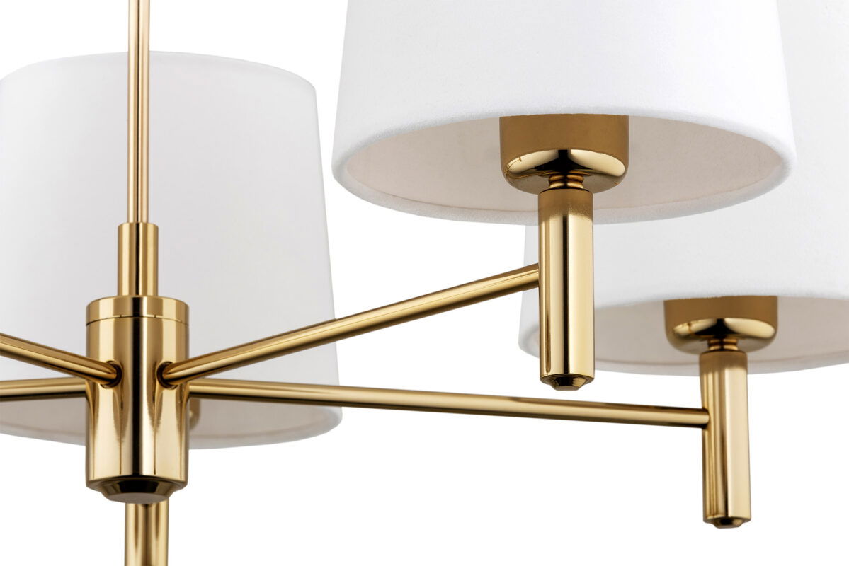 Zoomed in view of one of five arms from a brass chandelier.