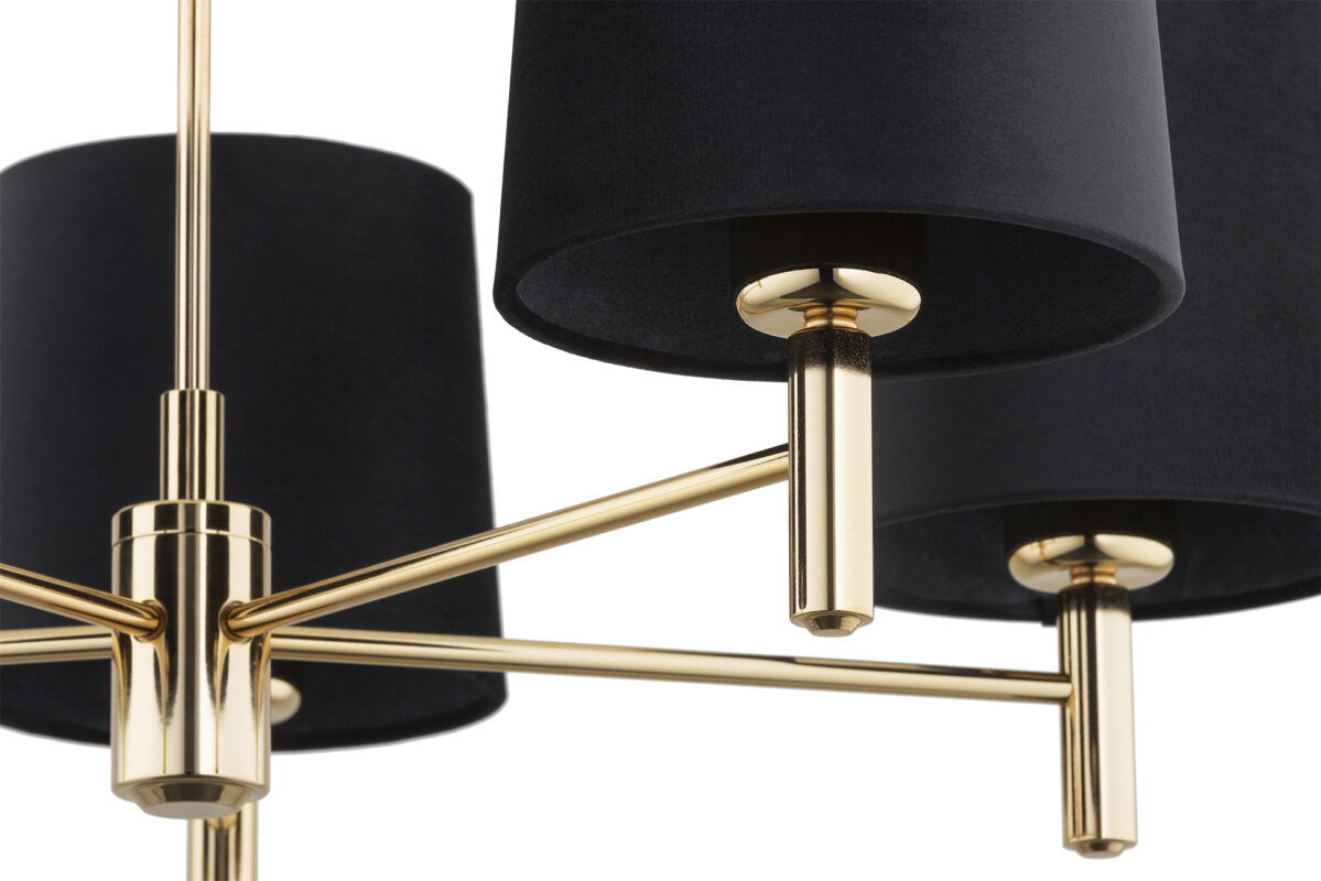 Zoomed in view of a brass arm with lamp holder and black shade.
