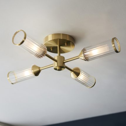 Upward view of the Mauris Flush Ceiling Lamp with brass frame, glass shade, and four light bulbs, installed on a ceiling.