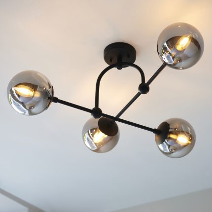 Direct upward view of the Luca Ceiling Light with four glass lamps and a black frame, installed on a ceiling.