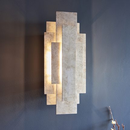 Left side view of the Platea Silver Wall Light at eye level on a blue wall.