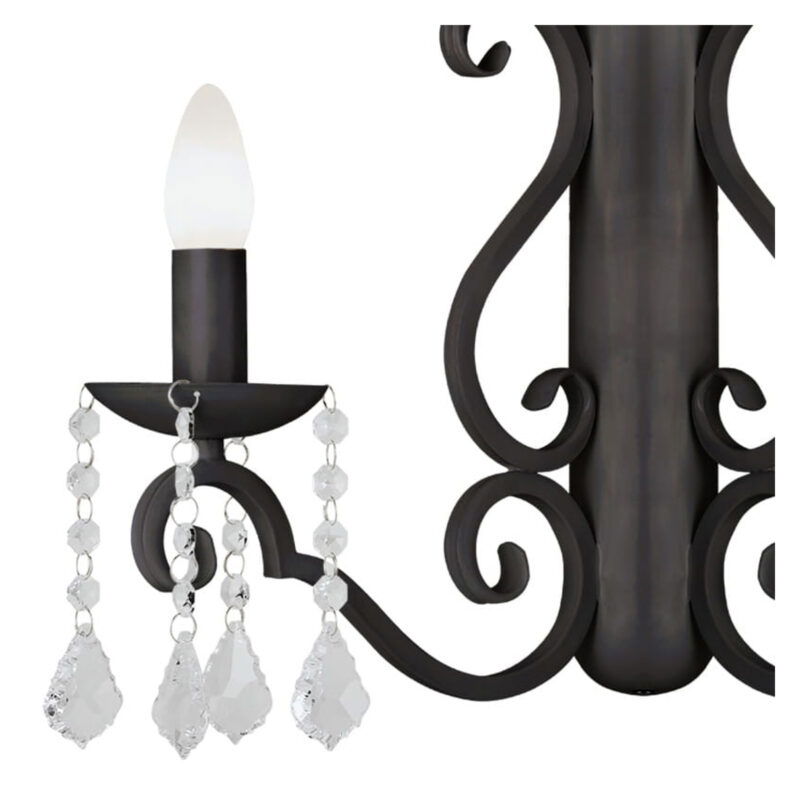 Close-up of black Dema wall light showing candle holder with crystal droplets and scroll detailing.